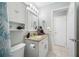 Bright bathroom featuring granite countertops and a classic white vanity with ample storage at 14884 Cromwell Dr, Clearwater, FL 33764