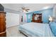 Bright bedroom featuring tile flooring, a closet, and complementary blue accents at 14884 Cromwell Dr, Clearwater, FL 33764