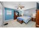 Spacious bedroom featuring a ceiling fan, tile flooring, and complementary blue accents at 14884 Cromwell Dr, Clearwater, FL 33764
