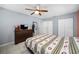 Bedroom featuring neutral tile floor, ceiling fan, closet and window offering great natural light at 14884 Cromwell Dr, Clearwater, FL 33764