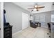 Bedroom with closet and window offering great natural light, furnished with ceiling fan, recliner chair and a writing desk at 14884 Cromwell Dr, Clearwater, FL 33764
