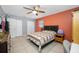 Bedroom featuring neutral tile floor, ceiling fan, closet and window offering great natural light at 14884 Cromwell Dr, Clearwater, FL 33764