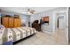 Bedroom featuring neutral tile floor, ceiling fan, closet and window offering great natural light at 14884 Cromwell Dr, Clearwater, FL 33764