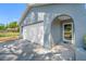 Covered front entrance to home; single car garage and white rock landscaping detail at 14884 Cromwell Dr, Clearwater, FL 33764