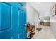 Inviting foyer featuring a vibrant blue front door and a convenient console table with shelving at 14884 Cromwell Dr, Clearwater, FL 33764