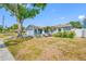 Charming single Gathering home with a two-car garage and mature tree in front yard at 14884 Cromwell Dr, Clearwater, FL 33764