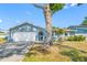Charming single Gathering home with a two-car garage and mature tree in front yard at 14884 Cromwell Dr, Clearwater, FL 33764