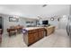 Open-concept layout with kitchen island, dining area, and living space, perfect for entertaining at 14884 Cromwell Dr, Clearwater, FL 33764