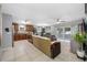 Open living room featuring tile floors, modern furnishings, and a seamless flow into the updated kitchen and bright outdoor space at 14884 Cromwell Dr, Clearwater, FL 33764