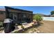 View of a screened in porch and backyard with tropical plants and a grill at 150 Tompkins St, Port Charlotte, FL 33954
