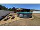 Backyard with above ground pool, stone landscaping and lounge chairs at 150 Tompkins St, Port Charlotte, FL 33954