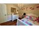 Charming bedroom featuring hardwood floors, pink accents, and ample natural light, creating a bright and inviting space at 150 Tompkins St, Port Charlotte, FL 33954