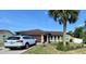 Inviting single-Gathering home with a well-manicured lawn and mature palm tree at 150 Tompkins St, Port Charlotte, FL 33954