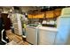 Organized laundry room with washer, dryer, storage, and appliances at 150 Tompkins St, Port Charlotte, FL 33954