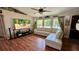 Inviting living room with a comfortable white sectional sofa, vaulted ceilings, and large windows at 150 Tompkins St, Port Charlotte, FL 33954