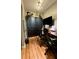 Home office featuring hard wood floors, storage, and a workspace at 150 Tompkins St, Port Charlotte, FL 33954