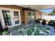 Inviting covered patio with stylish outdoor furniture, lush greenery, and ample space for relaxation and entertainment at 150 Tompkins St, Port Charlotte, FL 33954