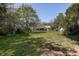 Beautiful backyard offers plenty of room for recreation, bordered by mature trees and landscaping at 17519 Drake Ct, Lutz, FL 33559