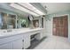 Bright bathroom featuring double sinks, neutral color palette, and natural light at 17519 Drake Ct, Lutz, FL 33559