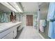 Spacious bathroom featuring double sinks, ample counter space, and a separate shower at 17519 Drake Ct, Lutz, FL 33559