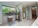 Well-lit bathroom showcasing a large window with lush garden views and a walk-in shower at 17519 Drake Ct, Lutz, FL 33559