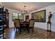 Dining room with dark wood furnishings, artwork, and a view to the landscaped outdoors at 17519 Drake Ct, Lutz, FL 33559