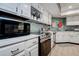 Close-up of kitchen with stainless steel appliances, white countertops, and decorative backsplash at 17519 Drake Ct, Lutz, FL 33559