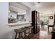 Eat-in kitchen showcasing barstool seating, decorative backsplash, and connection to the dining room at 17519 Drake Ct, Lutz, FL 33559