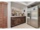Bright kitchen with stainless steel refrigerator and dark wood cabinets and drawers at 17519 Drake Ct, Lutz, FL 33559