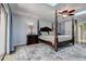 Cozy main bedroom with four-poster bed, skylight, and neutral tones for a relaxing atmosphere at 17519 Drake Ct, Lutz, FL 33559