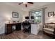 Home office space with wood-look floors, a pair of desks, lamps, and natural light at 17519 Drake Ct, Lutz, FL 33559