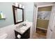 Bathroom vanity boasts granite countertop, ample storage, and stylish fixtures; access to hallway at 1975 W Bay Dr # 301, Largo, FL 33770