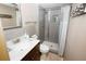 Stylish bathroom features a marble countertop, dark wood vanity, and walk-in shower at 1975 W Bay Dr # 301, Largo, FL 33770