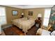 Bedroom featuring hardwood floors, plantation shutters, and tasteful decor for a peaceful retreat at 1975 W Bay Dr # 301, Largo, FL 33770
