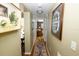 Inviting hallway features hardwood floors, neutral paint, and decorative accents leading to living spaces at 1975 W Bay Dr # 301, Largo, FL 33770