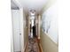 Well-lit hallway with hardwood floors, a decorative rug, and artwork create an inviting atmosphere at 1975 W Bay Dr # 301, Largo, FL 33770
