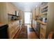 Clean kitchen featuring wooden cabinets, stainless steel appliances, and hardwood floors at 1975 W Bay Dr # 301, Largo, FL 33770