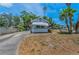 Quaint cottage with awning and front lawn, complemented by a driveway and partial fence at 2001 29Th N Ave, St Petersburg, FL 33713