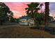 Beautiful home with lush landscaping, palm trees, and vibrant twilight sky at 2001 29Th N Ave, St Petersburg, FL 33713