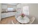 Cozy eat-in kitchen with white cabinetry, dining table, and a sunlit window at 2001 29Th N Ave, St Petersburg, FL 33713