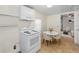 Cozy kitchen featuring white cabinets, modern appliances, and a nearby living area at 2001 29Th N Ave, St Petersburg, FL 33713