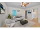 Bright living room with tile floors, modern furniture, and bright turquoise curtains at 2001 29Th N Ave, St Petersburg, FL 33713