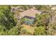 Aerial view of home featuring a screened pool and lush landscaping at 20632 Broadwater Dr, Land O Lakes, FL 34638