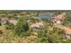 An aerial view of home in community with lush landscaping and scenic lake at 20632 Broadwater Dr, Land O Lakes, FL 34638