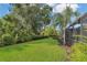 Private backyard features a lush lawn surrounded by tropical landscaping at 20632 Broadwater Dr, Land O Lakes, FL 34638