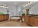 This bathroom features double sinks, a soaking tub, plantation shutters, and tile floors at 20632 Broadwater Dr, Land O Lakes, FL 34638