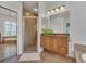 This bathroom features double sinks, a shower, and tile floors at 20632 Broadwater Dr, Land O Lakes, FL 34638