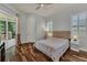 This bedroom features hardwood floors, a ceiling fan, and access to an outdoor patio at 20632 Broadwater Dr, Land O Lakes, FL 34638
