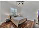 This bedroom features hardwood floors, a ceiling fan, and two nightstands with lamps at 20632 Broadwater Dr, Land O Lakes, FL 34638