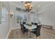 Bright dining room with decorative chandelier, large windows with plantation shutters, and seating for six at 20632 Broadwater Dr, Land O Lakes, FL 34638